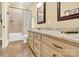 Bathroom with a large vanity, granite countertop, framed mirrors, and a shower-tub combination at 107 E Cold Hollow Farms Dr, Mooresville, NC 28117