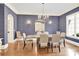 Formal dining room featuring a large table, statement mirror and textured wallpaper at 107 E Cold Hollow Farms Dr, Mooresville, NC 28117