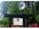 Community entrance with a vintage windmill, adorned with lush greenery and a welcome sign at 107 E Cold Hollow Farms Dr, Mooresville, NC 28117