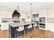 Beautiful kitchen with large granite island, stainless steel refrigerator, sleek range hood, and bar stool seating at 107 E Cold Hollow Farms Dr, Mooresville, NC 28117