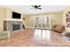 Open living room featuring a stone fireplace, tile floor, and sliding glass doors to the backyard at 107 E Cold Hollow Farms Dr, Mooresville, NC 28117