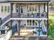 Two-story outdoor living space with a grill, patio furniture, and a ceiling fan at 107 E Cold Hollow Farms Dr, Mooresville, NC 28117