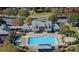 Aerial view of the community pool and clubhouse, surrounded by trees and lounge chairs at 107 E Cold Hollow Farms Dr, Mooresville, NC 28117