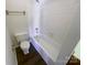 Bathroom with white tile, a bathtub, and dark vinyl flooring at 10945 Carmel Crossing Rd, Charlotte, NC 28226