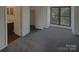 Bedroom with grey carpet, large window, and en-suite bathroom at 10945 Carmel Crossing Rd, Charlotte, NC 28226