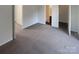 Spacious bedroom with grey carpet and access to two other rooms at 10945 Carmel Crossing Rd, Charlotte, NC 28226