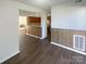 Dining area with wood-look floors and a view of the kitchen at 10945 Carmel Crossing Rd, Charlotte, NC 28226