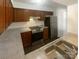 Efficient kitchen with wood cabinets and stainless steel appliances at 10945 Carmel Crossing Rd, Charlotte, NC 28226