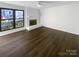 Bright living room with hardwood floors and a fireplace at 10945 Carmel Crossing Rd, Charlotte, NC 28226