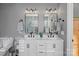 Stylish bathroom with double vanity, contemporary lighting, and a large mirror, offering a functional and elegant space at 11414 Coreopsis Rd, Charlotte, NC 28213