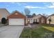 Charming single-story home with brick accents, a two-car garage, and a well-manicured front lawn at 11414 Coreopsis Rd, Charlotte, NC 28213