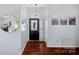 Inviting foyer with hardwood floors, decorative lighting, and a view into the living areas at 11414 Coreopsis Rd, Charlotte, NC 28213