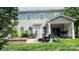 The backyard boasts a stone fire pit, patio seating, and covered porch at 117 Tomahawk Dr, Mooresville, NC 28117