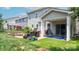 Backyard featuring a stone fire pit, patio furniture, and a covered porch at 117 Tomahawk Dr, Mooresville, NC 28117