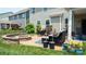 Backyard patio with comfortable seating and a stone fire pit at 117 Tomahawk Dr, Mooresville, NC 28117