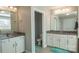 A spacious bathroom is well lit with double sinks and mirrors at 117 Tomahawk Dr, Mooresville, NC 28117