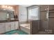 This bathroom is well-lit with a soaking tub and large glass shower at 117 Tomahawk Dr, Mooresville, NC 28117