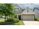Charming craftsman style home with a two-car garage and manicured front yard at 117 Tomahawk Dr, Mooresville, NC 28117