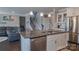 Modern kitchen island featuring granite countertops, stainless steel appliances, and pendant lighting at 117 Tomahawk Dr, Mooresville, NC 28117