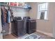 Well-organized laundry room featuring side-by-side washer and dryer, overhead shelving, and a window for natural light at 117 Tomahawk Dr, Mooresville, NC 28117