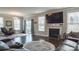 Elegant living room featuring a fireplace, dark wood floors, and a stylish area rug at 117 Tomahawk Dr, Mooresville, NC 28117