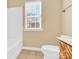 Bright bathroom with a toilet, bathtub, and vanity at 1227 Mountain Laurel Ct, Matthews, NC 28104