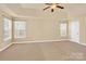 Spacious bedroom with carpeted floors, ceiling fan and multiple windows at 1227 Mountain Laurel Ct, Matthews, NC 28104