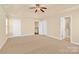 Main bedroom with carpet, ceiling fan and access to en-suite bathroom at 1227 Mountain Laurel Ct, Matthews, NC 28104