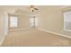 Large bedroom with carpeted floors, ceiling fan and multiple windows at 1227 Mountain Laurel Ct, Matthews, NC 28104