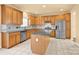 Modern kitchen with light wood cabinets, stainless steel appliances, and an island at 1227 Mountain Laurel Ct, Matthews, NC 28104