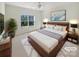 Virtually staged bedroom with a king-size bed and large window at 133 Jacobs Woods Cir, Troutman, NC 28166