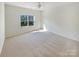 Bright bedroom with a large window and carpeted floor at 133 Jacobs Woods Cir, Troutman, NC 28166