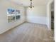 Bright dining room with carpeted floor and large window at 133 Jacobs Woods Cir, Troutman, NC 28166