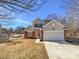 Two-story house with attached garage and landscaping at 133 Jacobs Woods Cir, Troutman, NC 28166