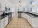 Modern kitchen with white cabinets, stainless steel appliances and tile floor at 133 Jacobs Woods Cir, Troutman, NC 28166