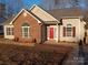 Brick and siding ranch home with red door and landscaped yard at 1331 Copper Creek Ln, Fort Mill, SC 29715