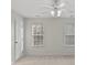 Bright bedroom with neutral walls, carpet, and two windows at 13443 Norseman Ln, Huntersville, NC 28078