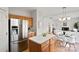 Modern kitchen with stainless steel refrigerator and island at 13443 Norseman Ln, Huntersville, NC 28078