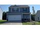 Two-story house with blue siding, white garage door, and landscaping at 1514 Doran Ter, Richburg, SC 29729