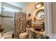 Bathroom with a vintage sink, tile shower, and decorative accents at 1519 Triplett Rd, Cleveland, NC 27013