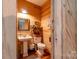 Rustic half-bath with wood walls and pedestal sink at 1519 Triplett Rd, Cleveland, NC 27013