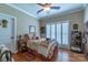 Bright bedroom includes a full-size bed, window shutters, and hardwood floors at 1519 Triplett Rd, Cleveland, NC 27013