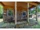 Quaint cabin with wooden rocking chair and porch swing at 1519 Triplett Rd, Cleveland, NC 27013