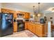 Galley style kitchen boasts wood cabinets and black appliances at 1519 Triplett Rd, Cleveland, NC 27013