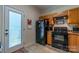 Cozy kitchen with wood cabinets, black appliances, and exterior access at 1519 Triplett Rd, Cleveland, NC 27013