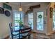 Charming kitchen nook features a rustic table, access to a patio, and a view of the backyard at 1519 Triplett Rd, Cleveland, NC 27013