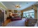 Spacious main bedroom with large windows, ceiling fan, and hardwood floors at 1519 Triplett Rd, Cleveland, NC 27013