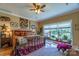 Main bedroom features a rustic bed, large window, and ceiling fan at 1519 Triplett Rd, Cleveland, NC 27013