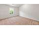 Bright bedroom with neutral walls and carpeting, featuring a window with natural light at 1524 Doran Ter, Richburg, SC 29729