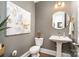 Chic half bathroom with a pedestal sink, elegant mirror, and modern decor for added flair at 1575 Riverwalk Pkwy, Rock Hill, SC 29730